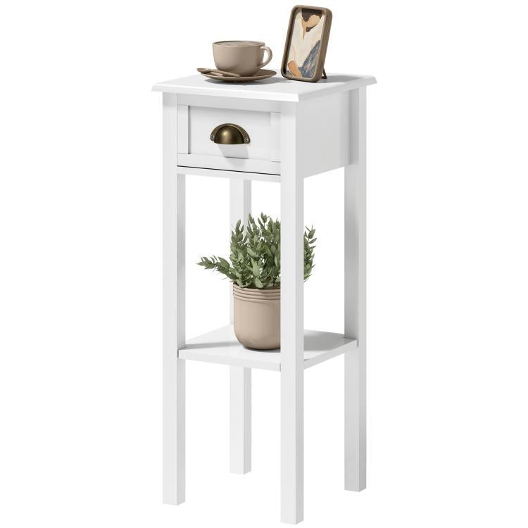 White end table with drawer and lower shelf, gold-tone handle and tabletop items