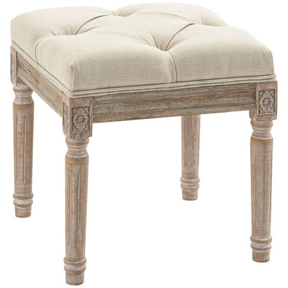 Beige upholstered ottoman bench with button-tufted seat and carved wooden legs