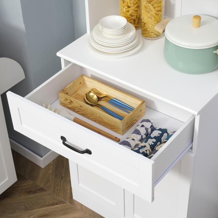 White cabinet drawer open with wooden organizer tray and utensils.