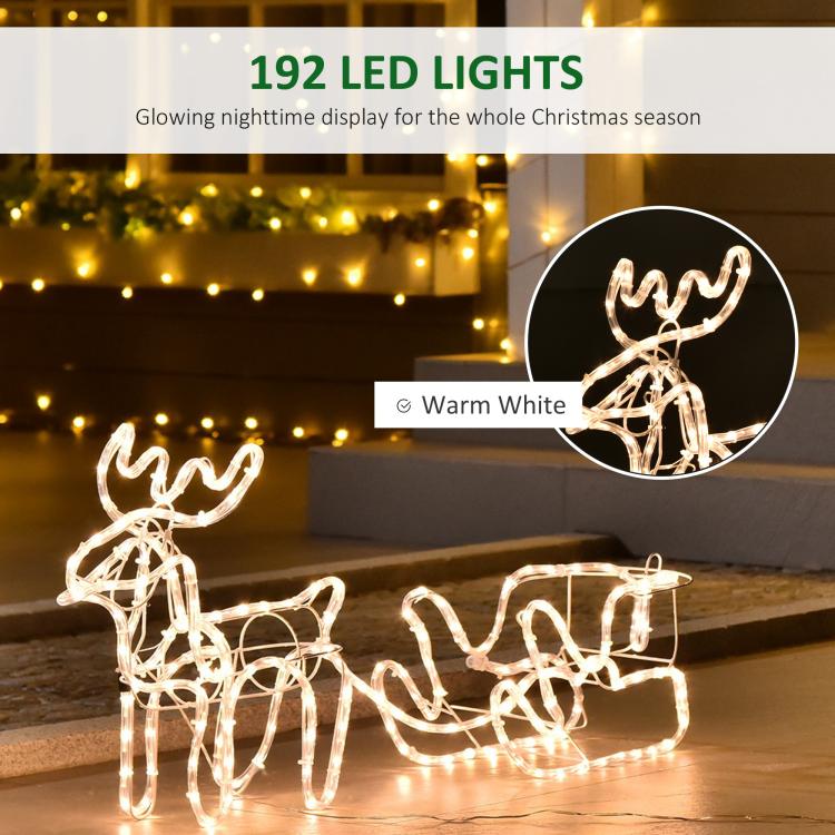 Warm white LED reindeer and sleigh yard decoration glowing on wire frame