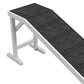 Foldable dog ramp with dark non-slip carpet top and white frame, angled close-up