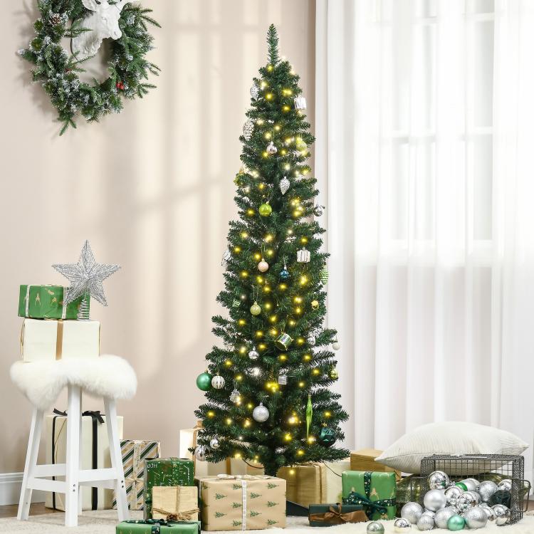 Pre-lit artificial Christmas tree with warm white lights, silver ornaments, and green needles.