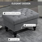 Gray button-tufted ottoman with nailhead trim and turned legs