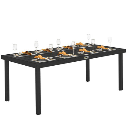 Rectangular outdoor dining table with black frame and faux wood slatted top