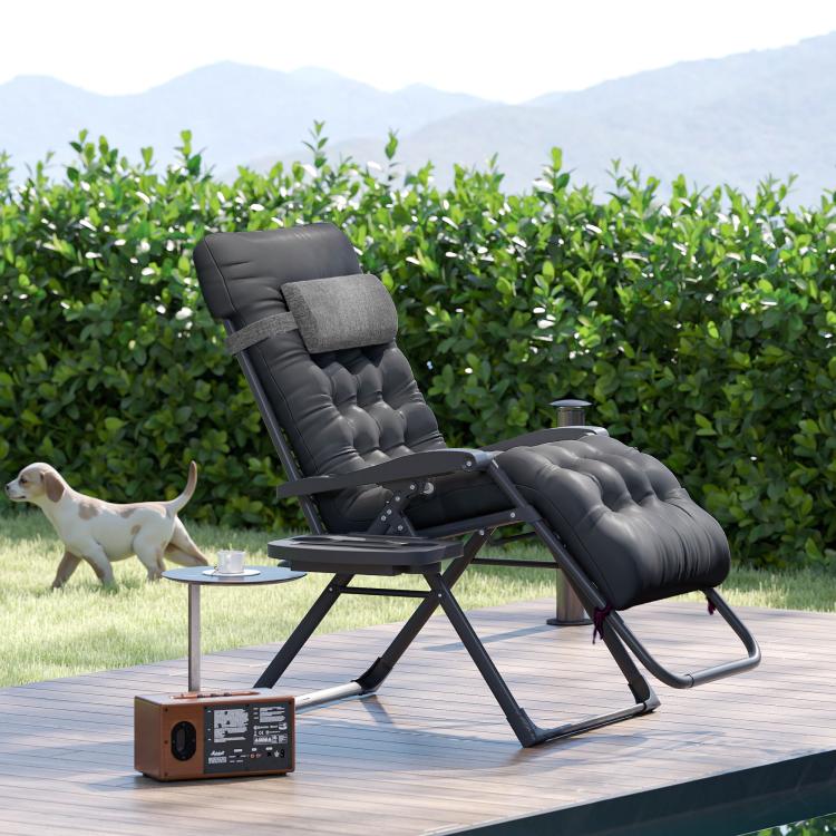 Black padded folding recliner chair with tufted cushioning in reclined position