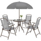 Round glass table with umbrella and four gray folding patio chairs