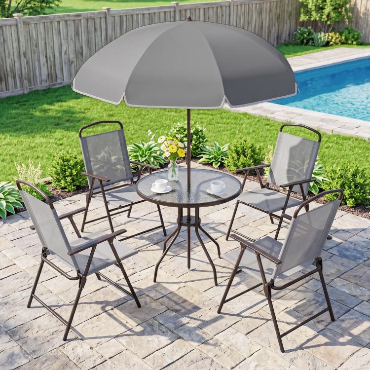 Outdoor patio dining set: gray umbrella, four folding chairs, round glass table