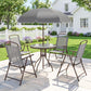 Outdoor gray patio dining set with umbrella over round glass table and four folding chairs