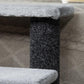 Close-up of dark scratching post and gray plush platform edge