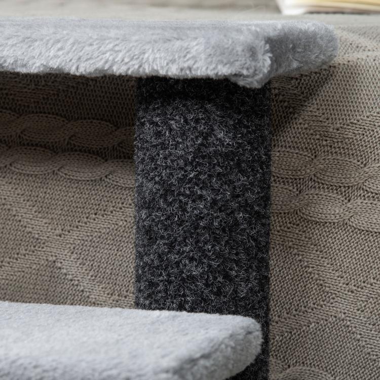 Close-up of dark scratching post and gray plush platform edge