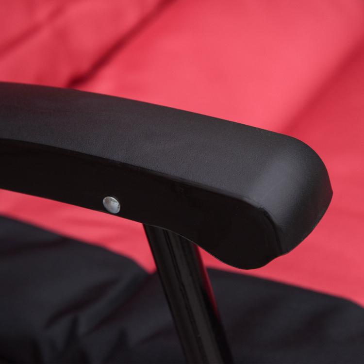 Close-up of red padded seat and black armrest on a rocking patio chair