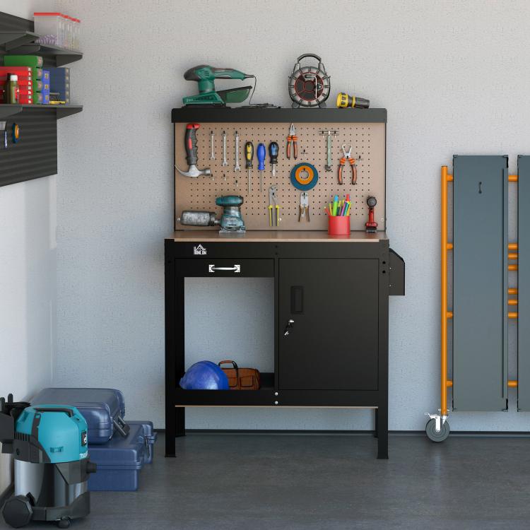 Black tool workbench with tan pegboard backing and storage cabinet with open lower shelf