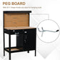 Black workbench with tan pegboard for hanging tools and a slide drawer