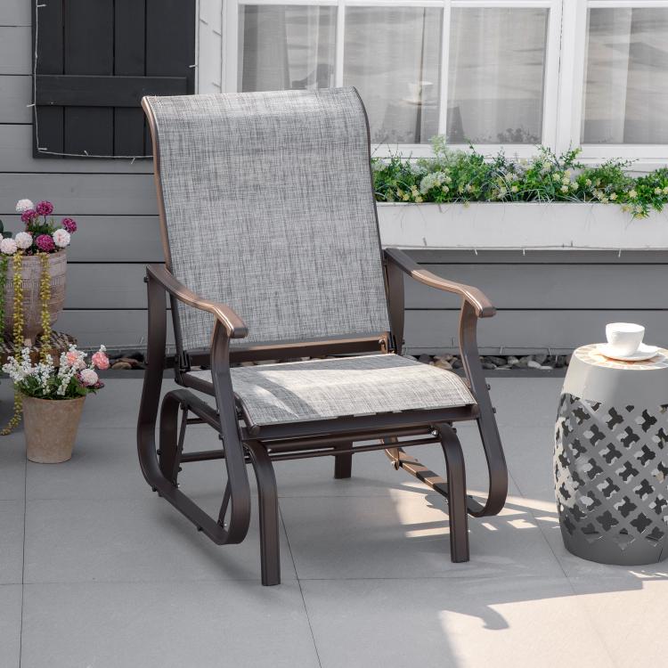 Gray outdoor rocking glider chair with tall backrest and curved armrests