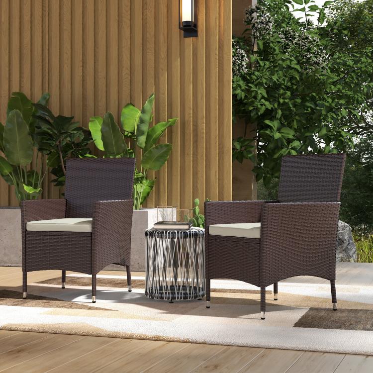 Outdoor patio chair set: dark coffee wicker chairs with white cushions and armrests