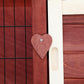 Heart-shaped wooden door latch on a two-level rabbit hutch with pull handle