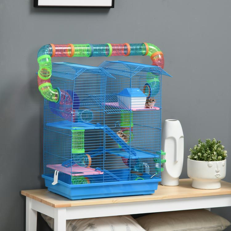 Blue hamster cage set with tunnels and a small pet on the inner platforms