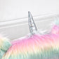 Close-up of rainbow unicorn plush chair horn and textured fluffy backrest