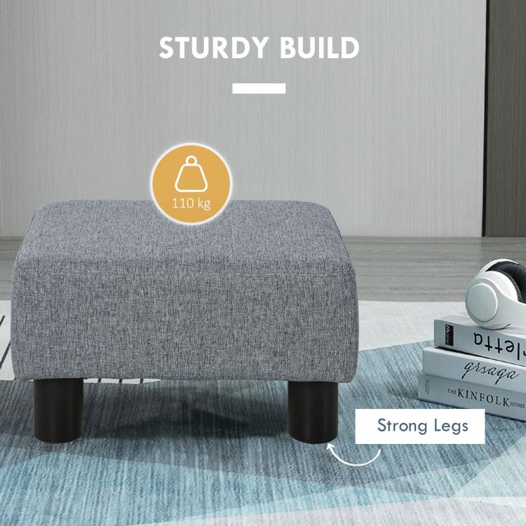 Gray cube ottoman foot stool with rounded fabric sides and black plastic legs