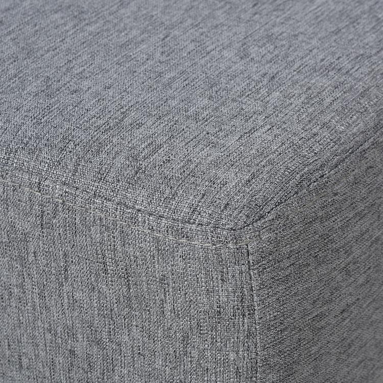 Gray textured fabric corner seam on a cube ottoman foot rest