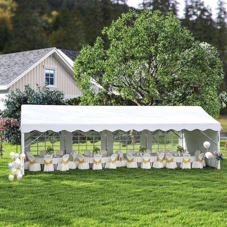 White party tent with arched window sidewalls and table seating inside