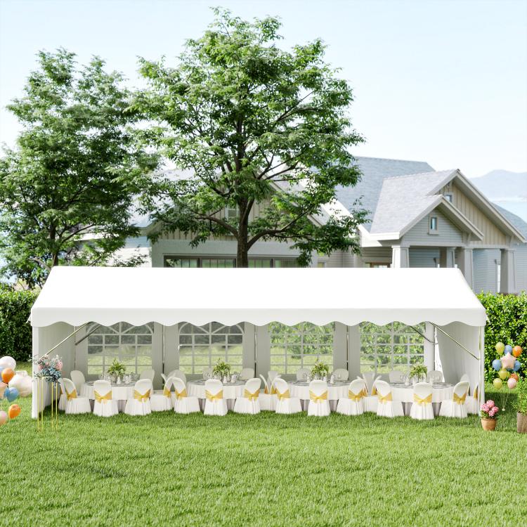 White outdoor event tent with arched window sidewalls and table setup