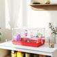 Red and white hamster cage on a tabletop with white wire enclosure and colorful accessories