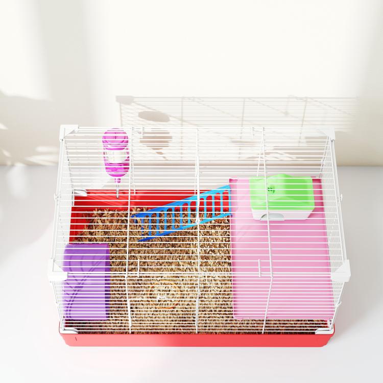 Hamster cage with bedding and purple accessories, pink water bottle, and green house