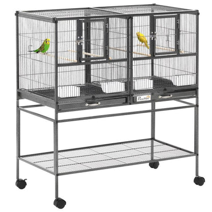 Divided metal bird cage on rolling stand with wood perches and removable tray