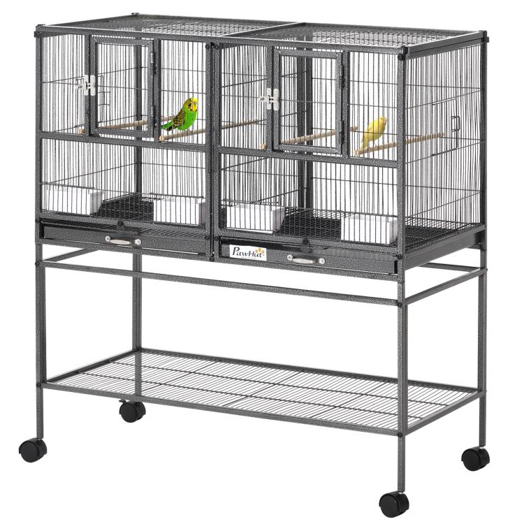 Divided metal bird cage with two sections, wood perches, and rolling stand