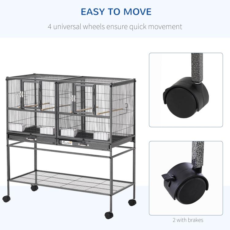 Divided metal bird cage on rolling stand with four universal wheels and braking casters