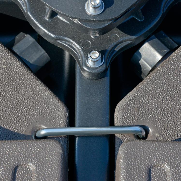 Close-up of umbrella base hardware mount with metal pin and bolts, dark brown