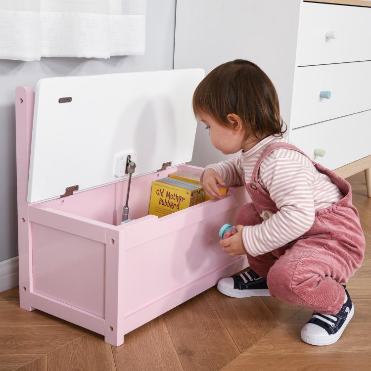 Pink toy storage bench with open lift-top lid and visible interior compartment