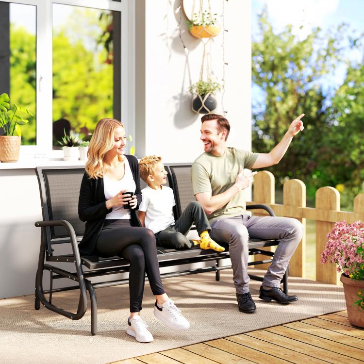 Outdoor porch glider bench with dark mesh seating and black curved armrests