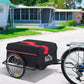 Bicycle cargo trailer with black removable cover and red stripe, hitched to bike