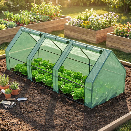 Green mini greenhouse with mesh sides, black steel frame, and leafy plants inside raised bed