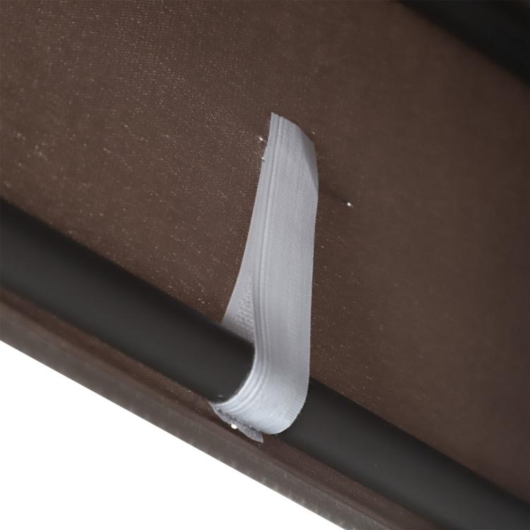 Close-up of brown fabric edge and stitched seam on dark metal porch swing frame
