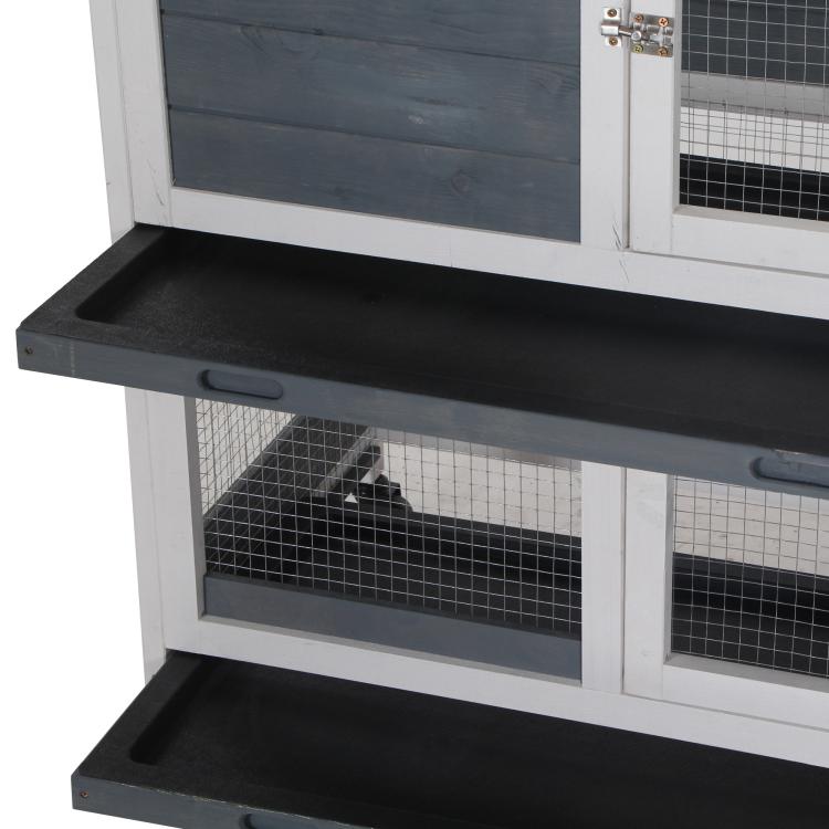 Close-up of elevated rabbit hutch plastic tray and wire mesh window, white frame