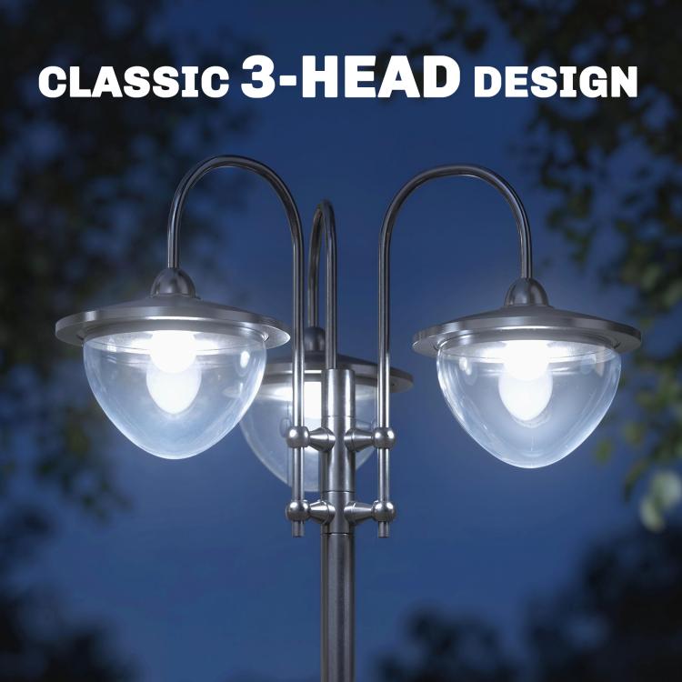 Three-head solar lamp post light close-up with frosted glass shades on dark metal