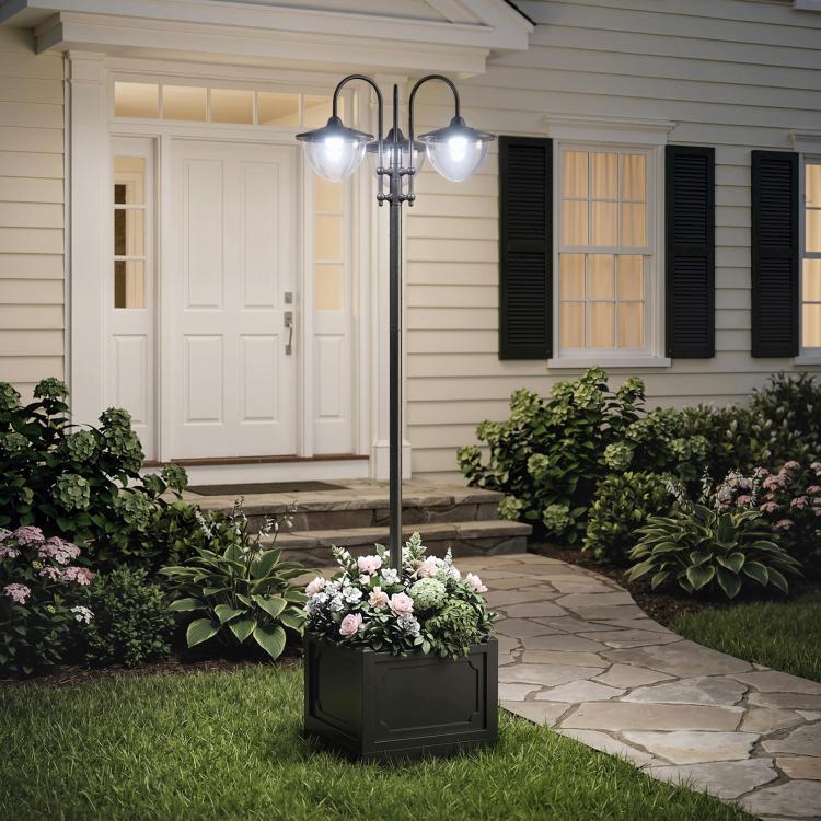 Three-head solar lamp post light with frosted glass shades next to square planter box
