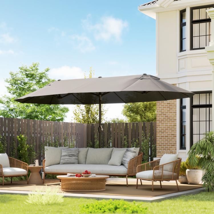 Gray double-sided patio umbrella shading a backyard seating area