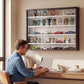 Black wall-mounted display cabinet with glass doors and five adjustable shelves