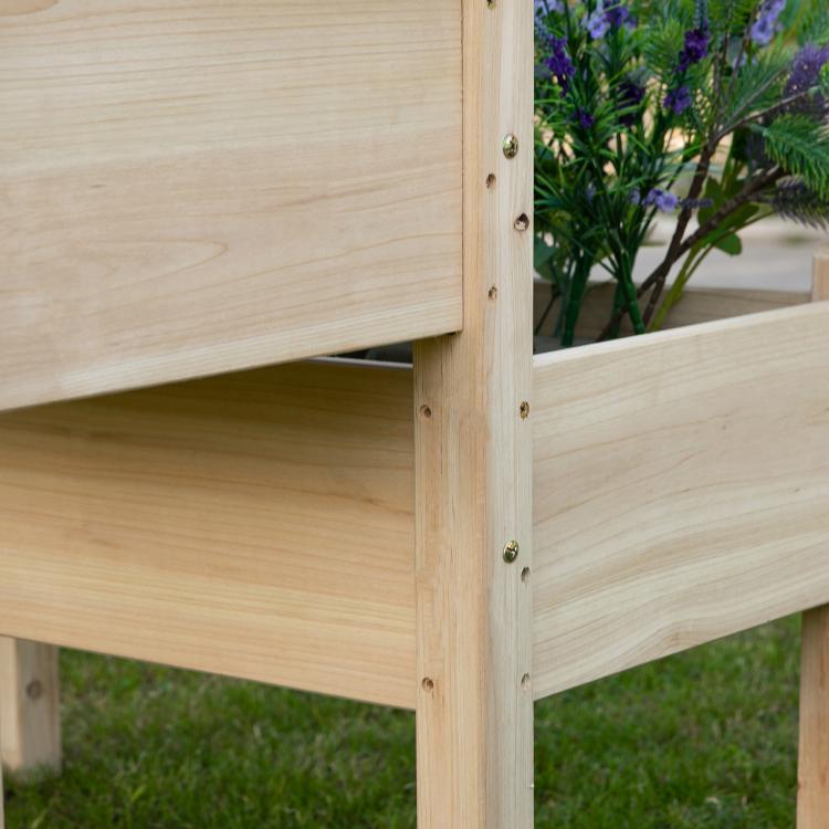 Close-up of two-tier wooden planter frame with metal screws and joint