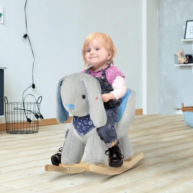 Plush bunny rocking horse toy with child seated, featuring blue padded seat and wooden rockers