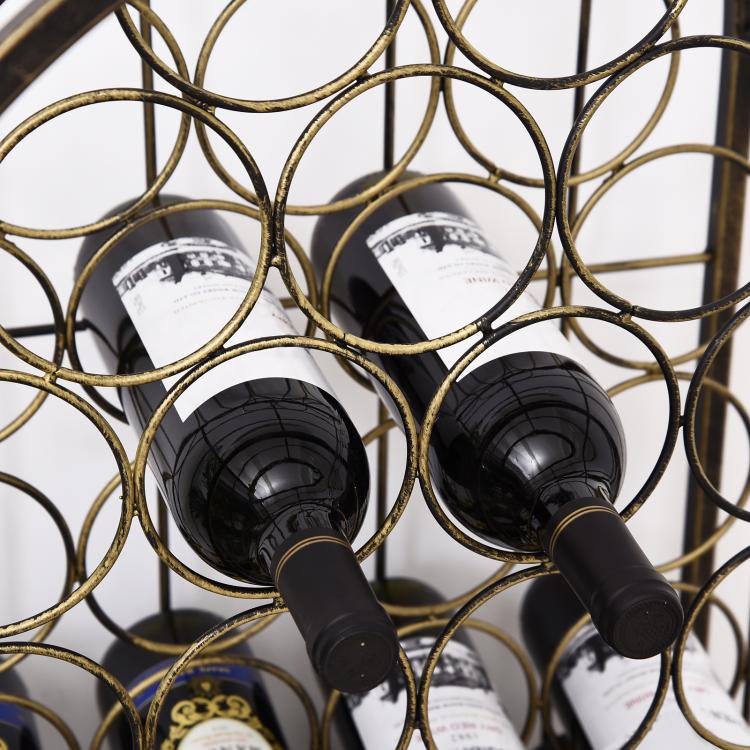 Dark wine bottles held in place by a bronze wrought-iron ring grid rack