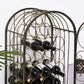 Bronze arched wine rack with bottles on shelves, wrought-iron scroll cage