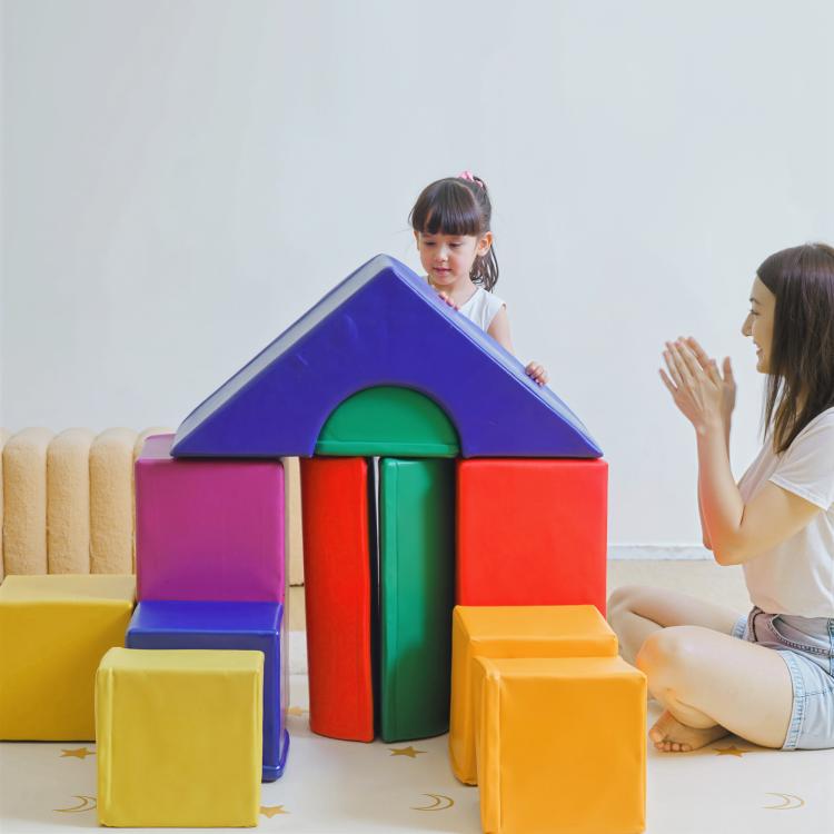 Kids playing on a multicolor foam crawl house with open tunnel and blocks