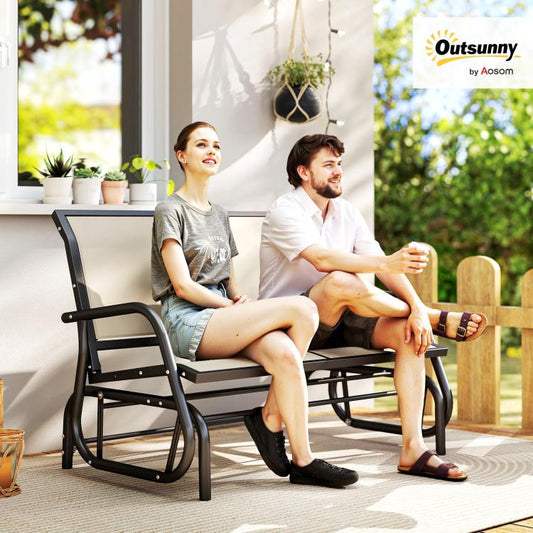 Outdoor glider bench with beige cushions; two people seated on the loveseat