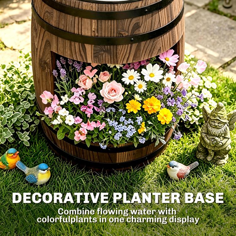 Close-up of rustic barrel fountain planter with multicolor flowers and decorative base
