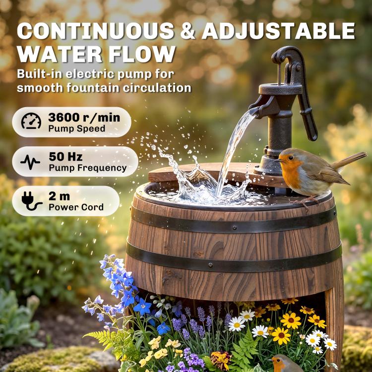 Rustic wooden barrel water fountain with black pump spraying water over blooming flowers